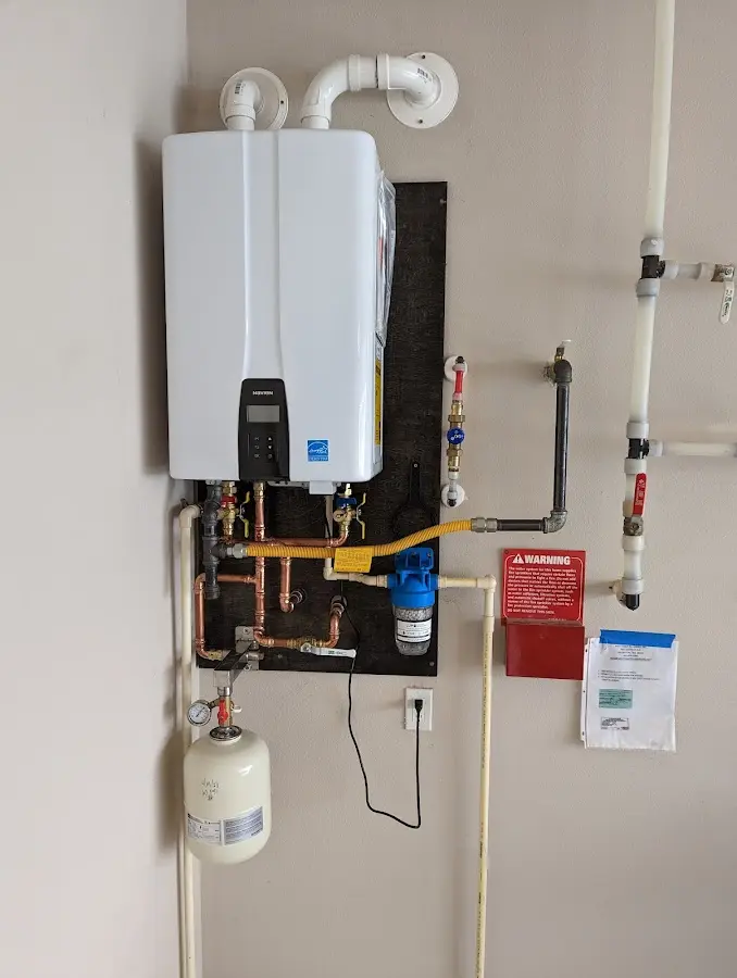 Professional plumber installing copper piping in a Ashford home